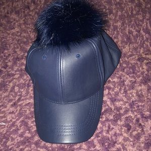 Leather hat with fur top ball